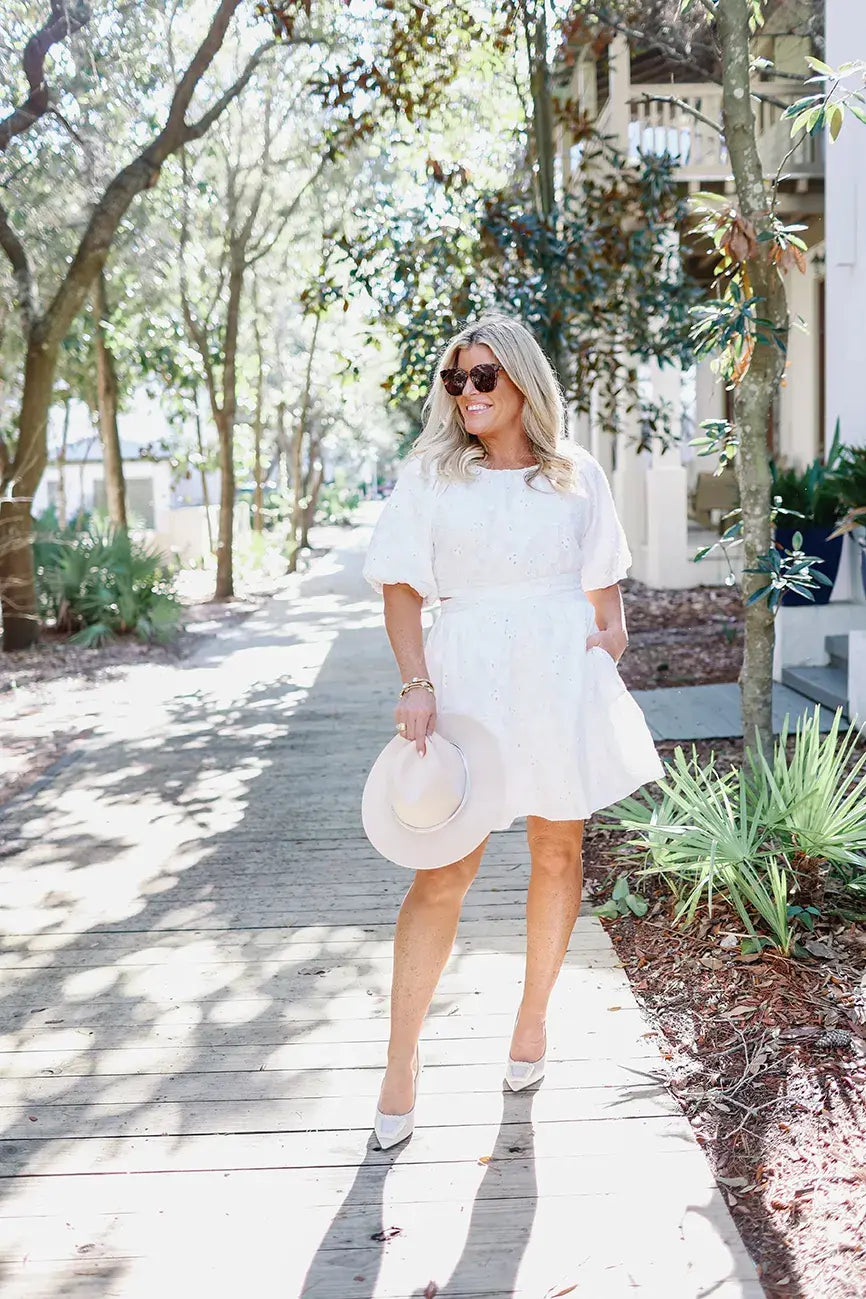 Photo of Chaz Easterly taken outdoors posing in a white dress and accessories by Linen & Flax Co.